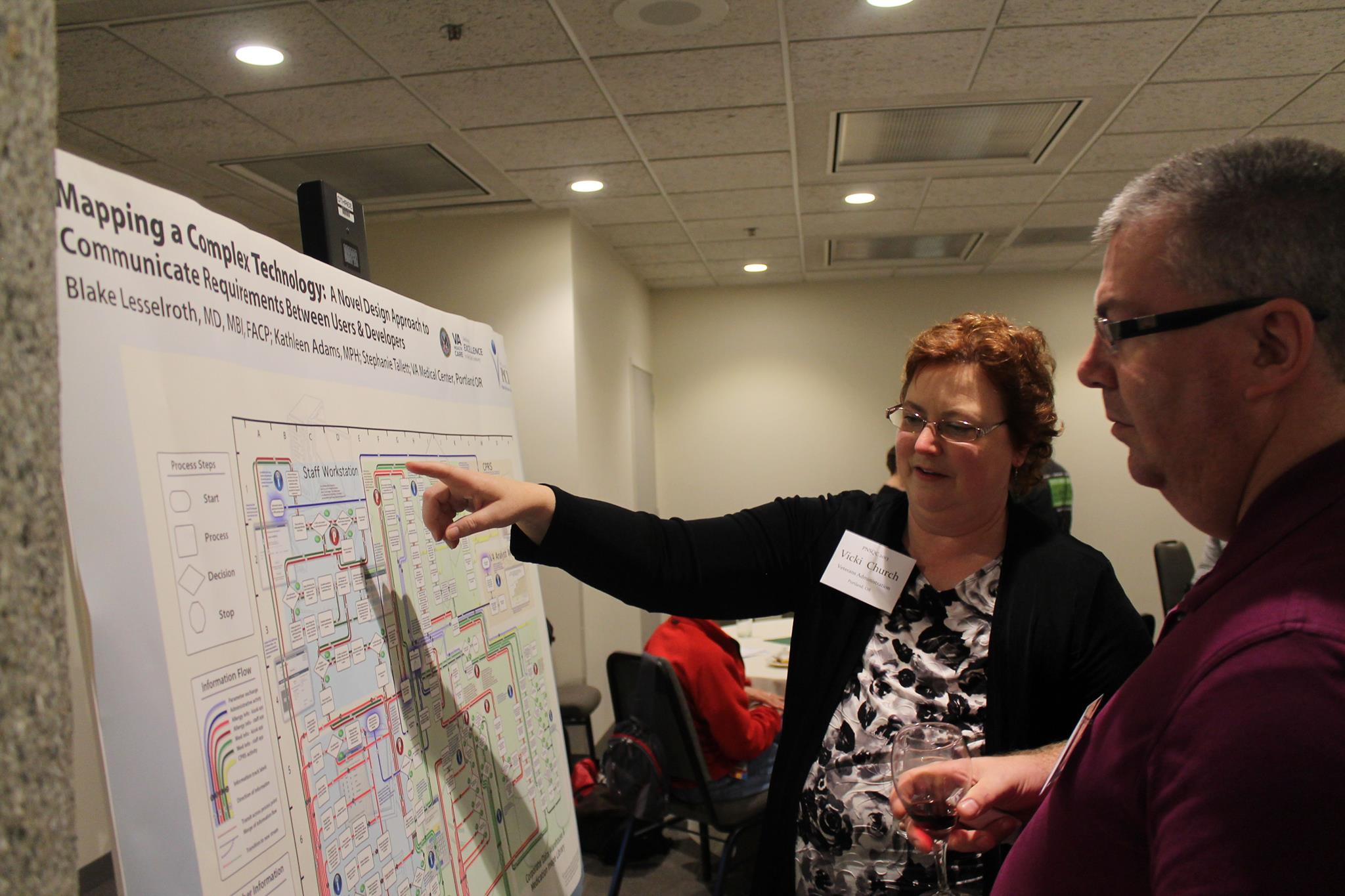 PNSQC attendees gathered around poster displays during networking